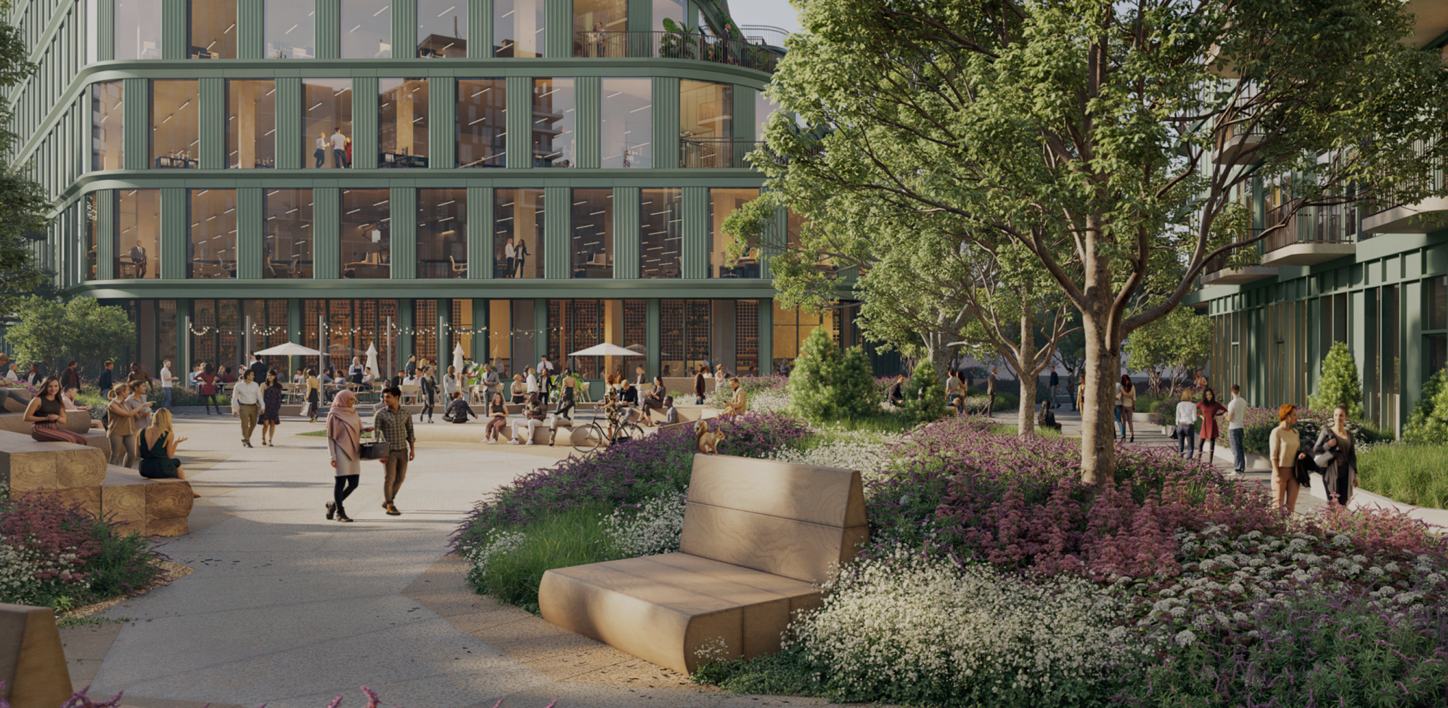 People walk along La Cienaga past Habitat's commercial office space next to the Expo Line Bikeway and light rail above